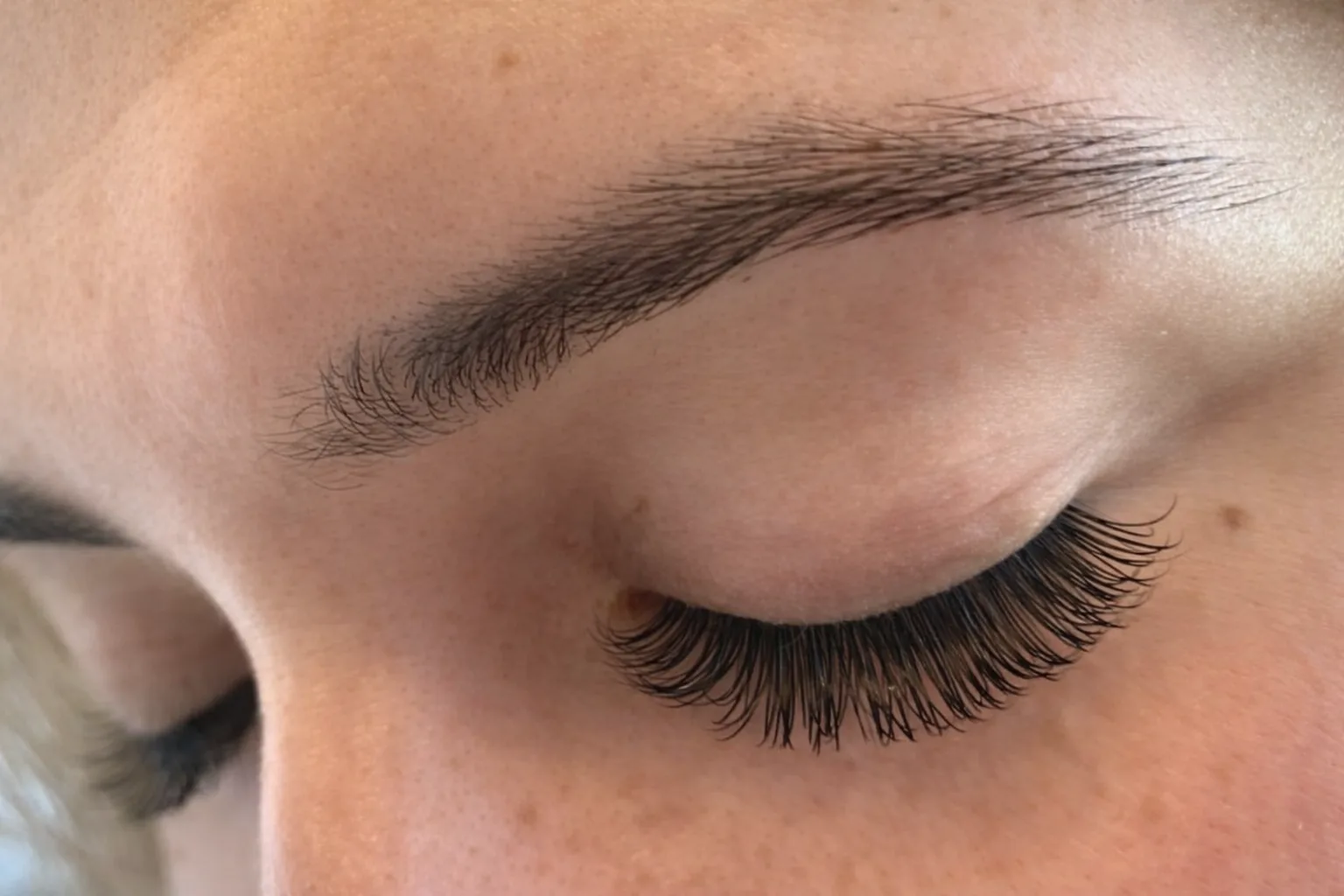 Lash extensions on a closed eye, showing even length along the lash line, K EYELASH & LIFT in Denville, NJ